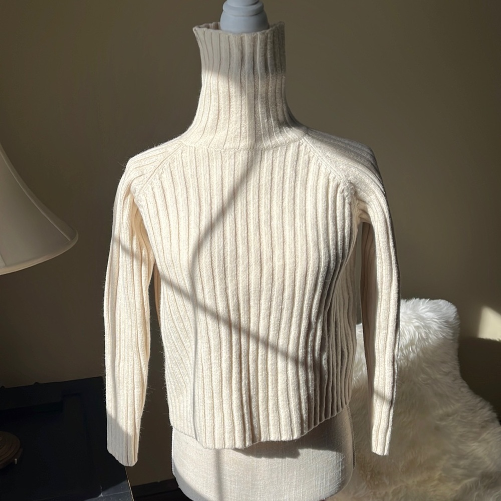 Merino wool, white turtle neck. Light stain on collar, unnoticeable when worn